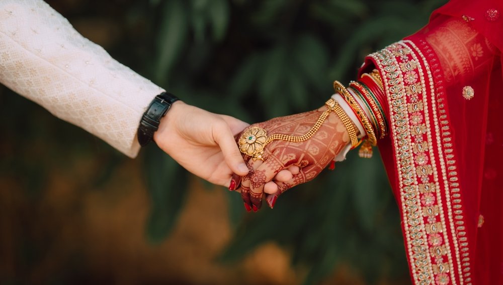 Indian,Wedding,Candid,Photo,Of,Groom,And,Bride,Holding,Hand