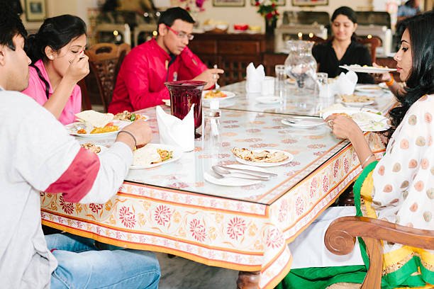 Friends eat together in a hotel restaurant, Jodhpur, Rajasthan, India.